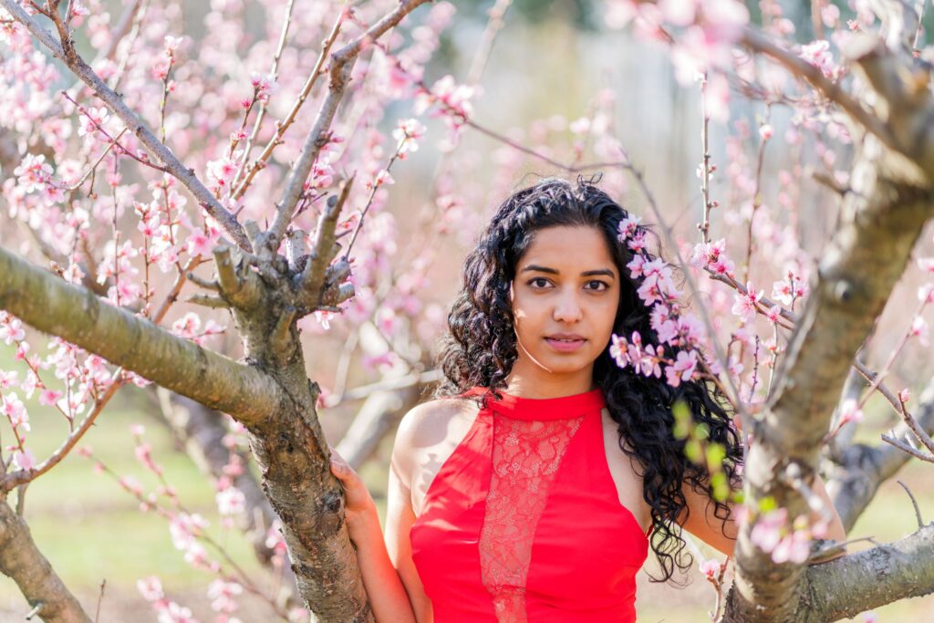 Model Minnie poses in a peach blossom orchard in Charlotte NC