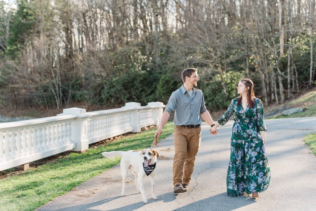 Jessica and Levi included their dog Beau in their photoshoot. Beau walks beside them as they hold hands and smile at each other