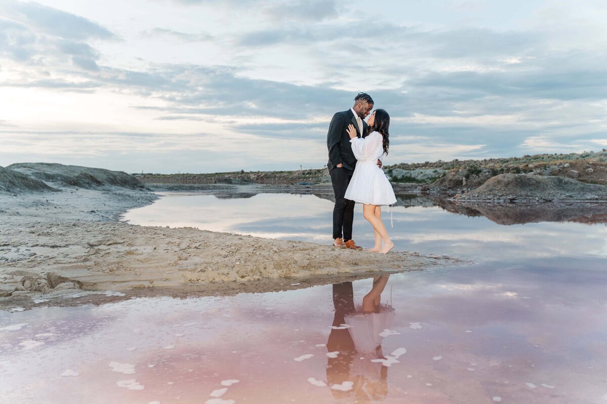 Rachel and Uyi embracing against the Stansbury Island pink lake backdrop at Stansbury Island