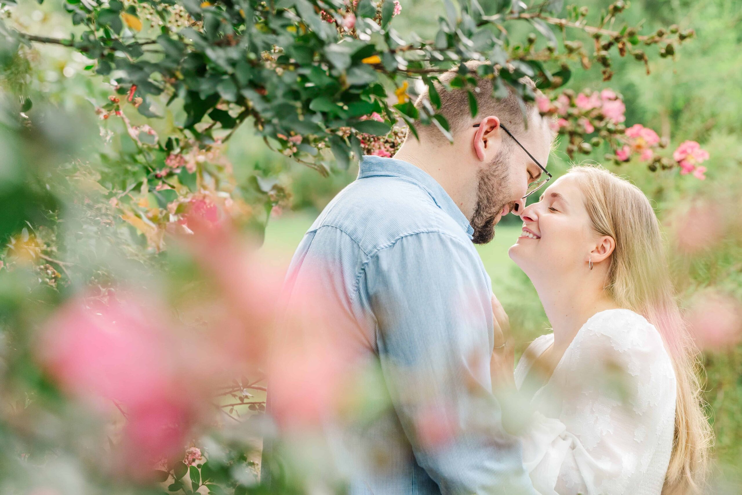 Emily and Daniel snuggle in the blooms at Glencairn Garden in Rock Hill, SC.