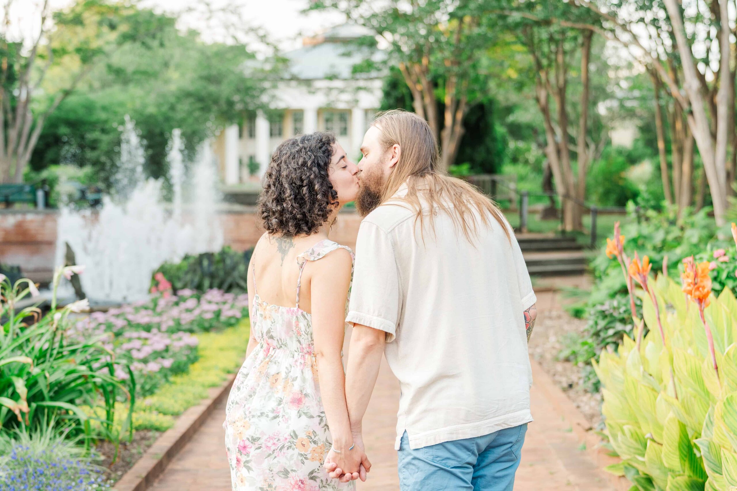 Engaged couple sharing a kiss during photo session at Daniel Stowe Botanical Gardens