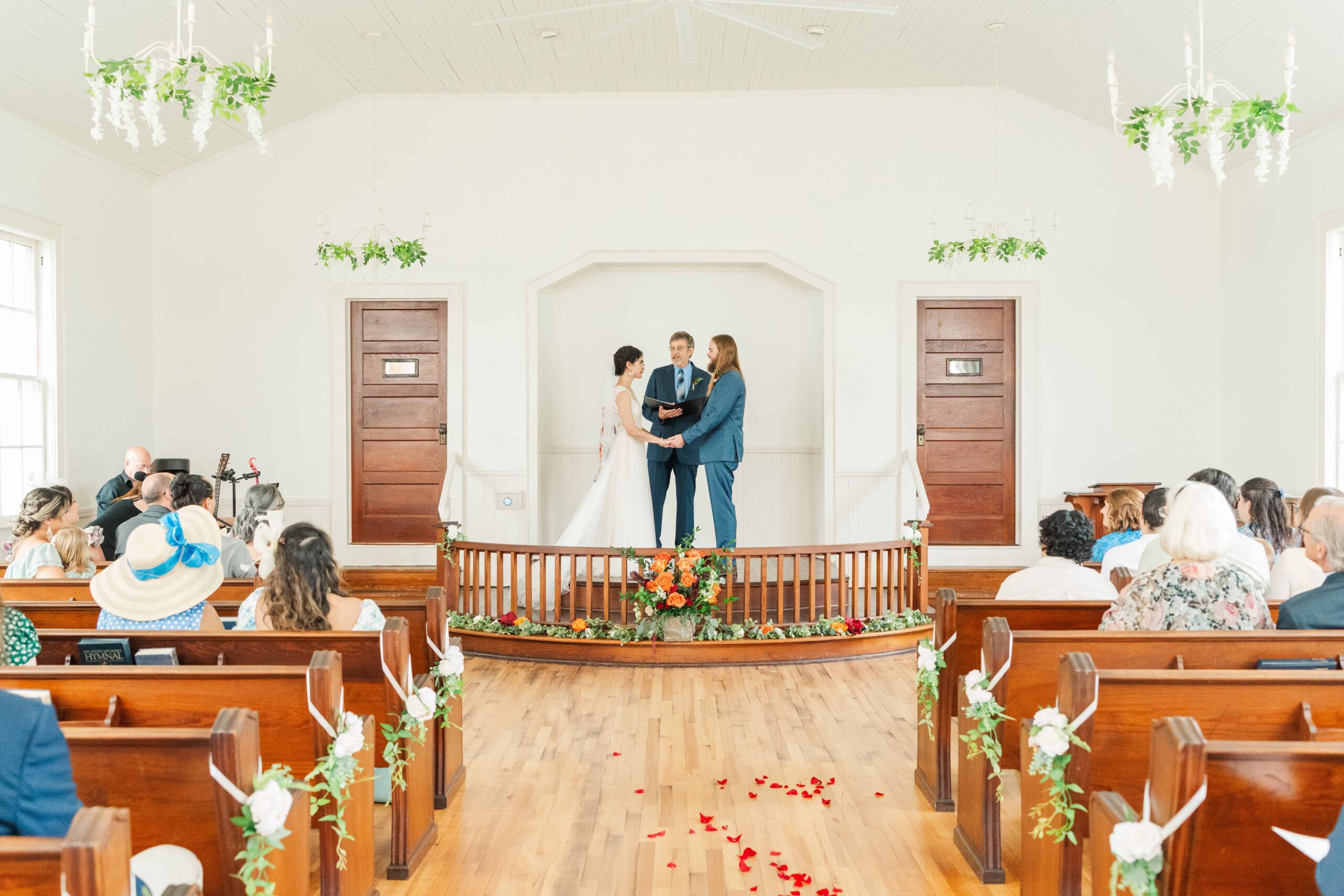 Intimate wedding ceremony inside historic chapel at Mariposa Chapel & Events