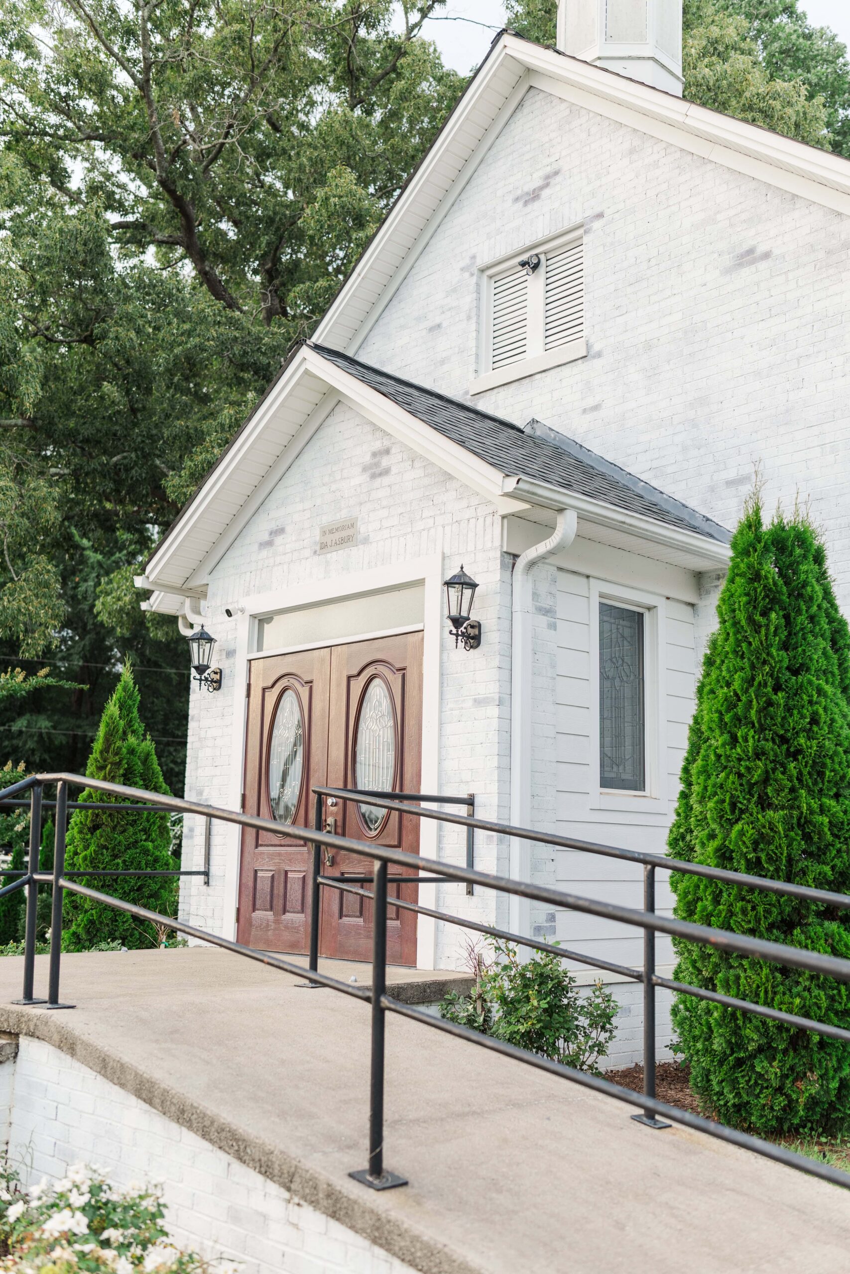 Exterior view of historic Mariposa Chapel surrounded by green garden