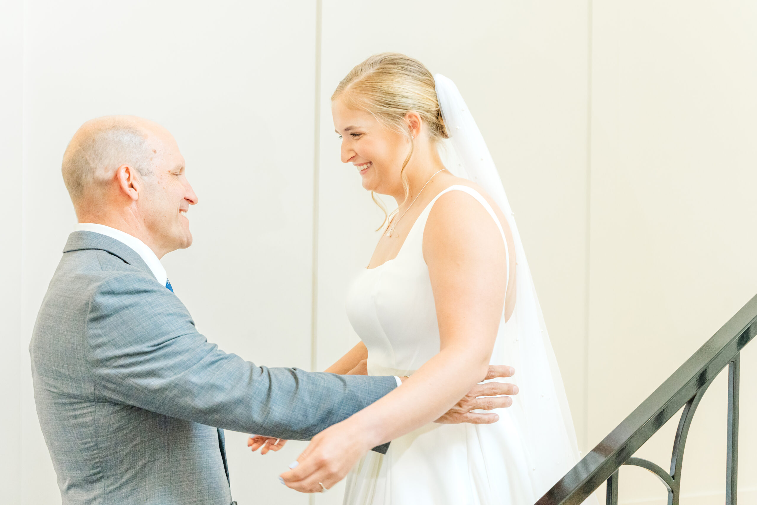 emotional father daughter first look on venue stairs