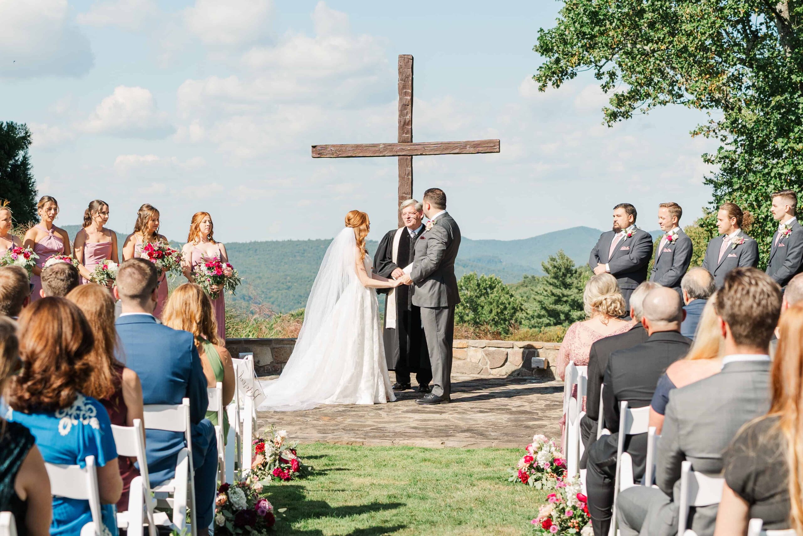 Couple holding hands during rustic charm outdoor ceremony