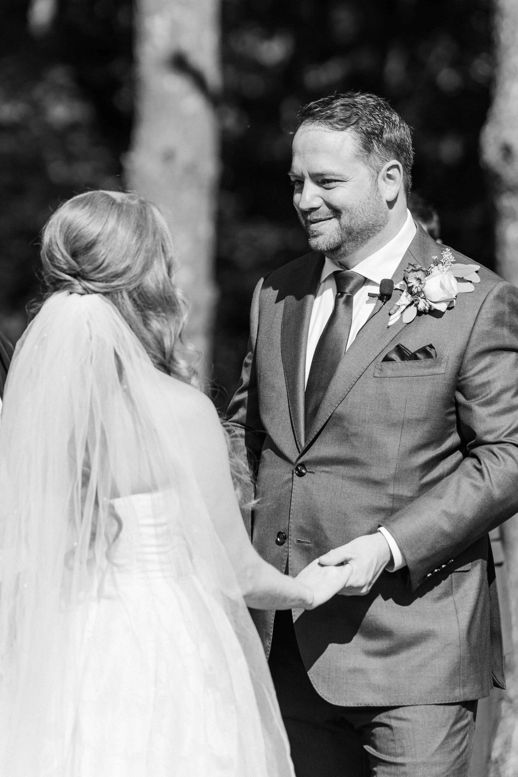 Groom smiling at bride during vows at Olde Beau Resort