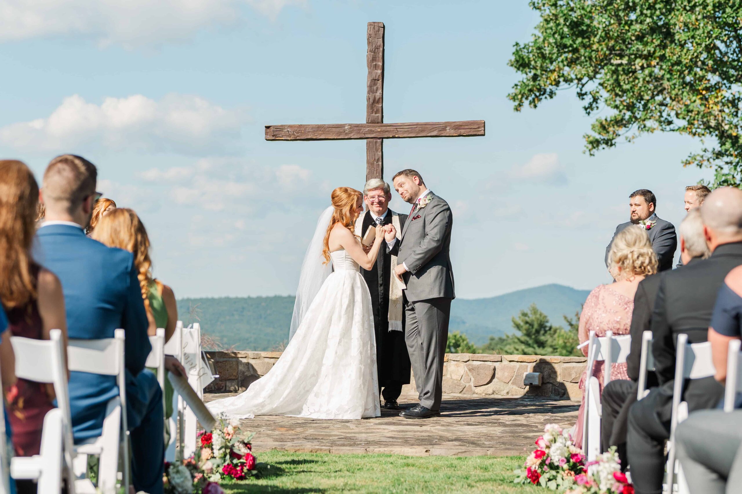 Outdoor wedding ceremony with entire family watching