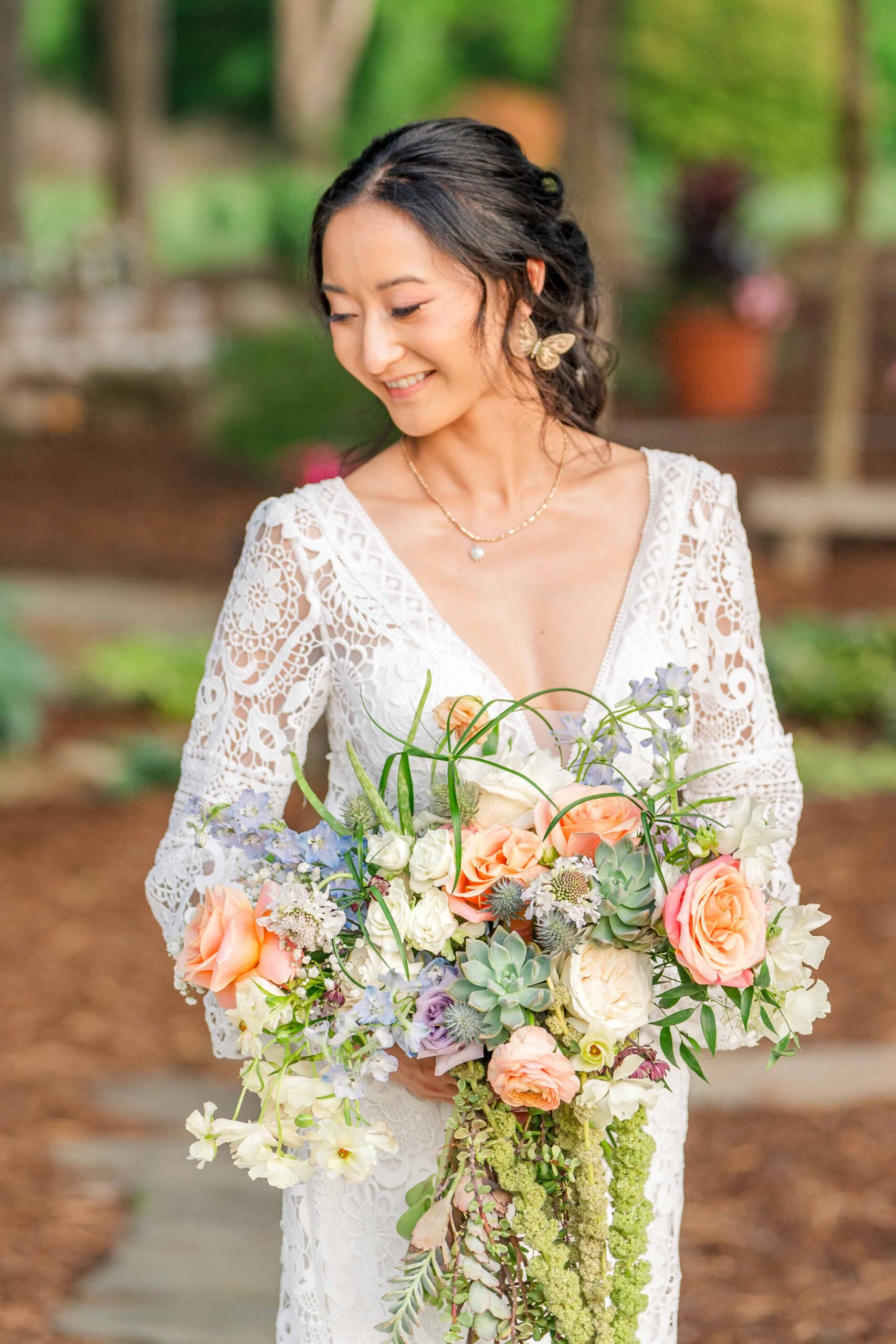 Bride posing in the garden with her bouquet