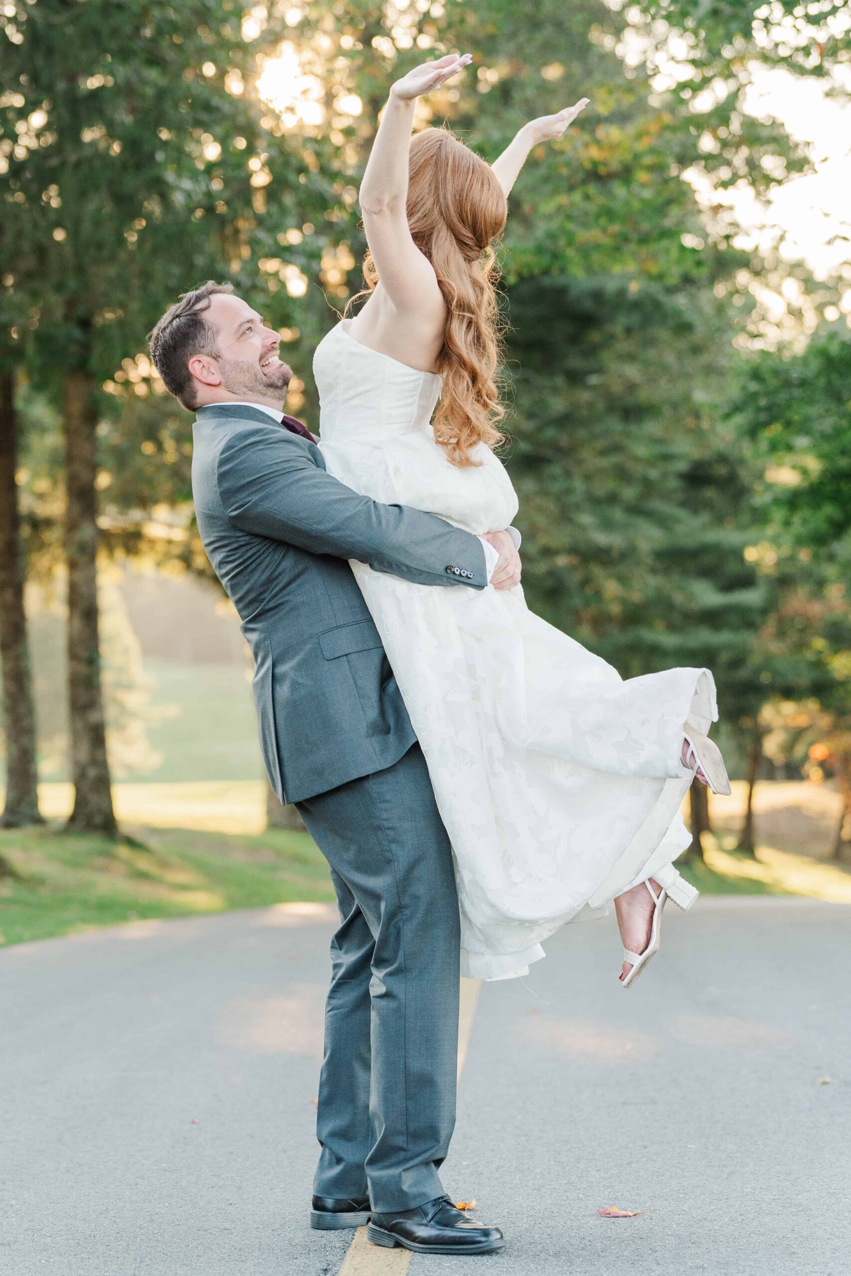 Bride and groom laughing during golden hour photos