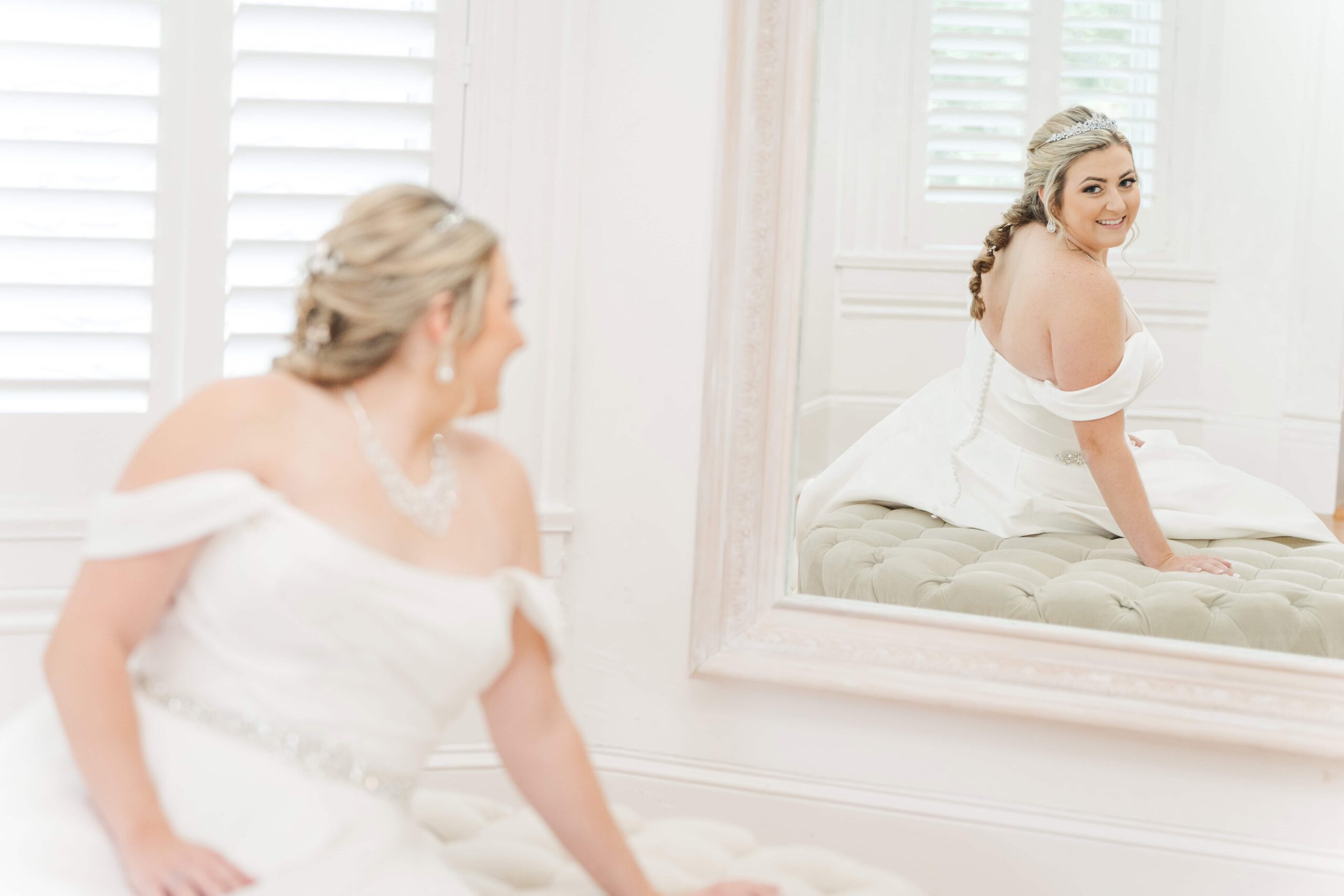 Bride getting ready in the bridal suite at The Grande Victorian with full length mirror and white tiles