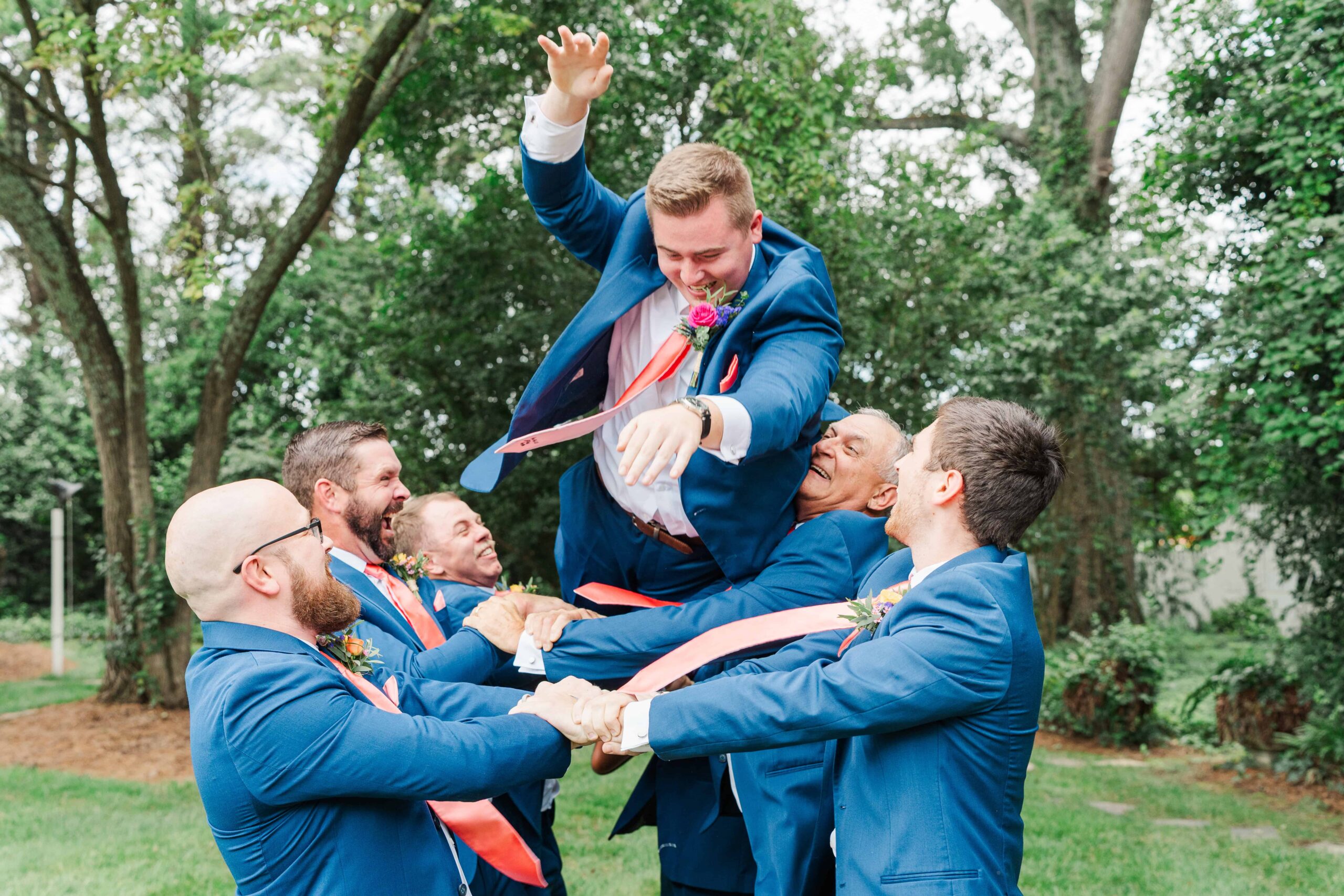 Groom laughing with groomsmen at The Grande Victorian before the wedding ceremony