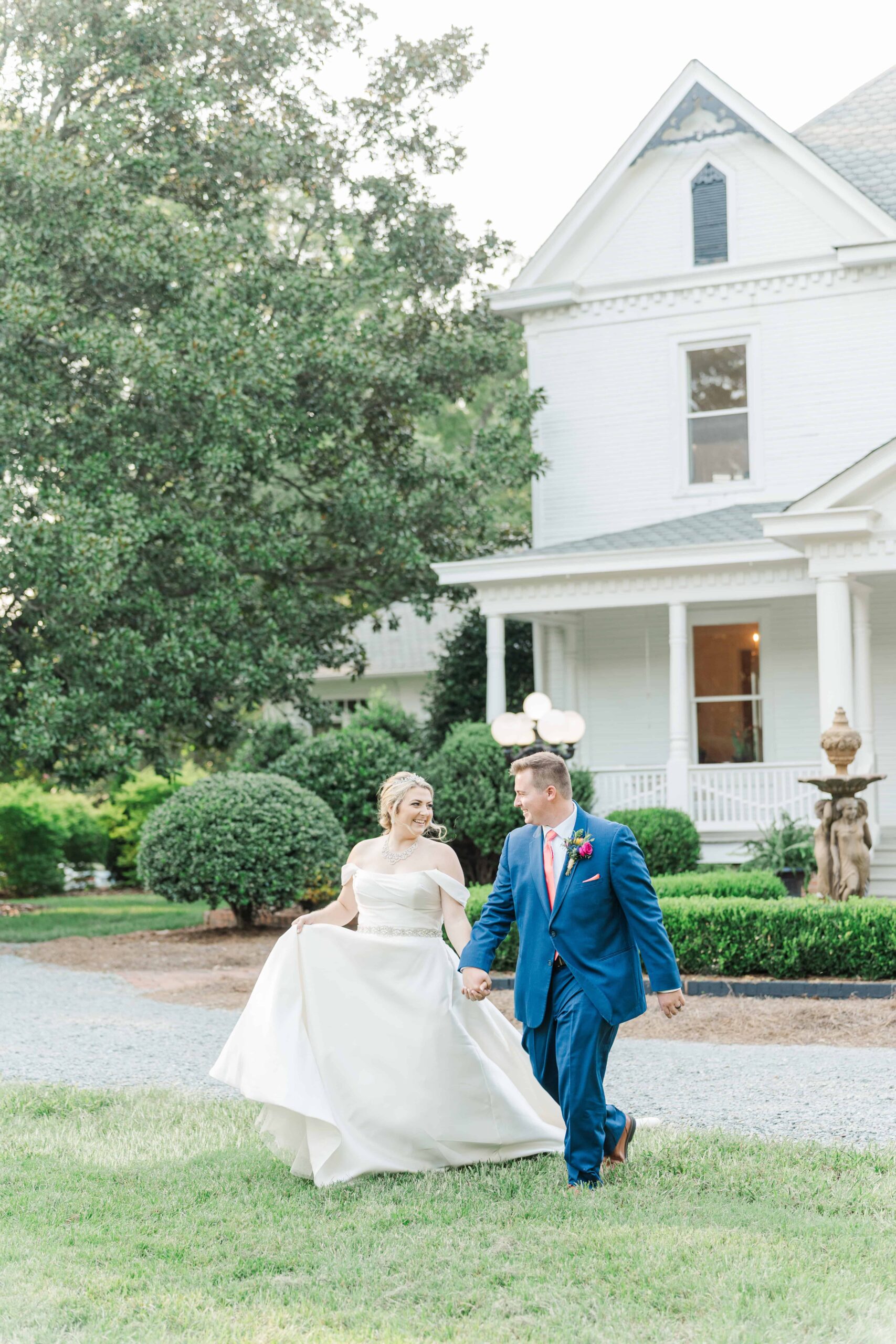 The Grande Victorian wedding photographer Monroe NC capturing candid moments in the gardens