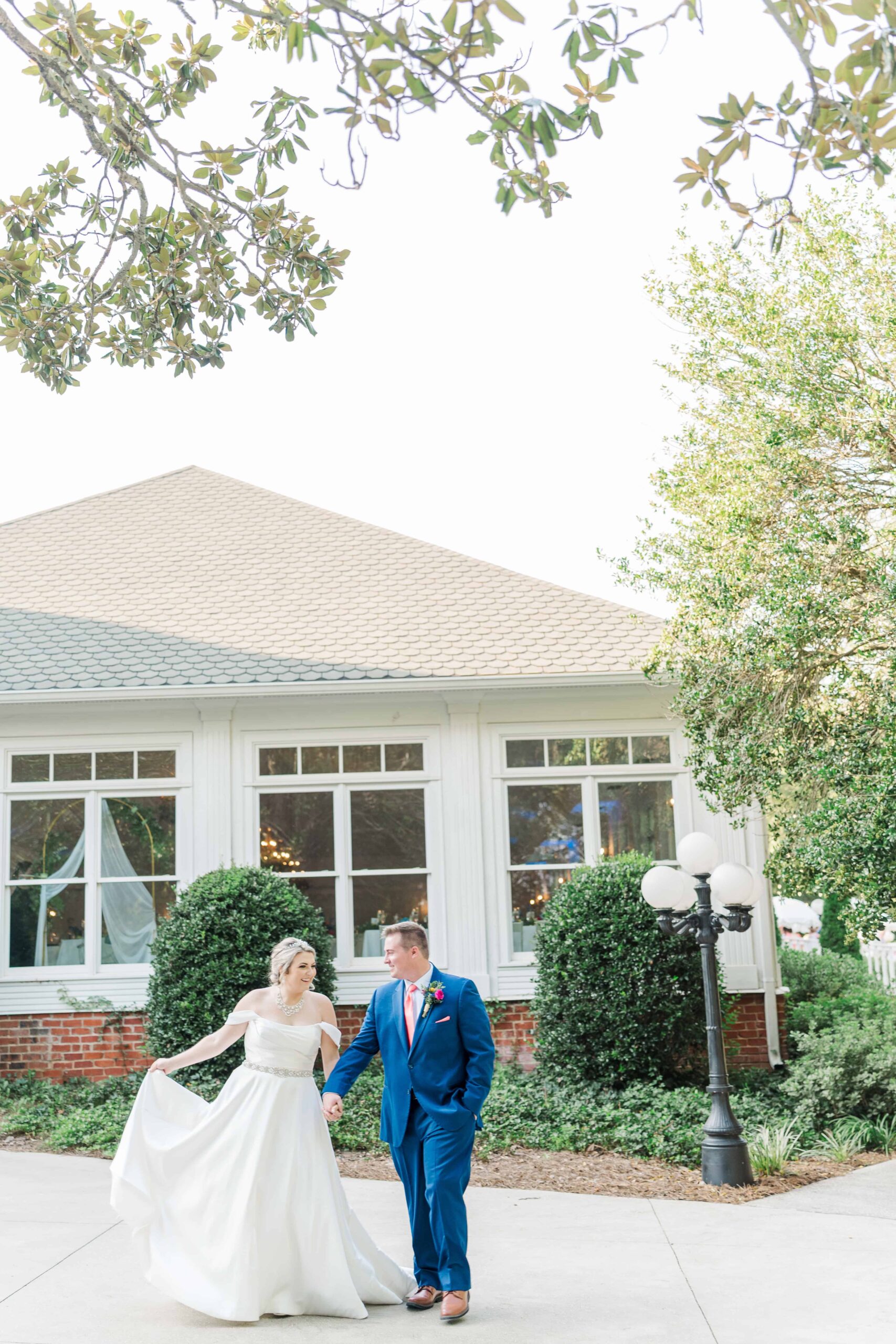 Couple walking hand in hand through outdoor spaces at The Grande Victorian during golden hour