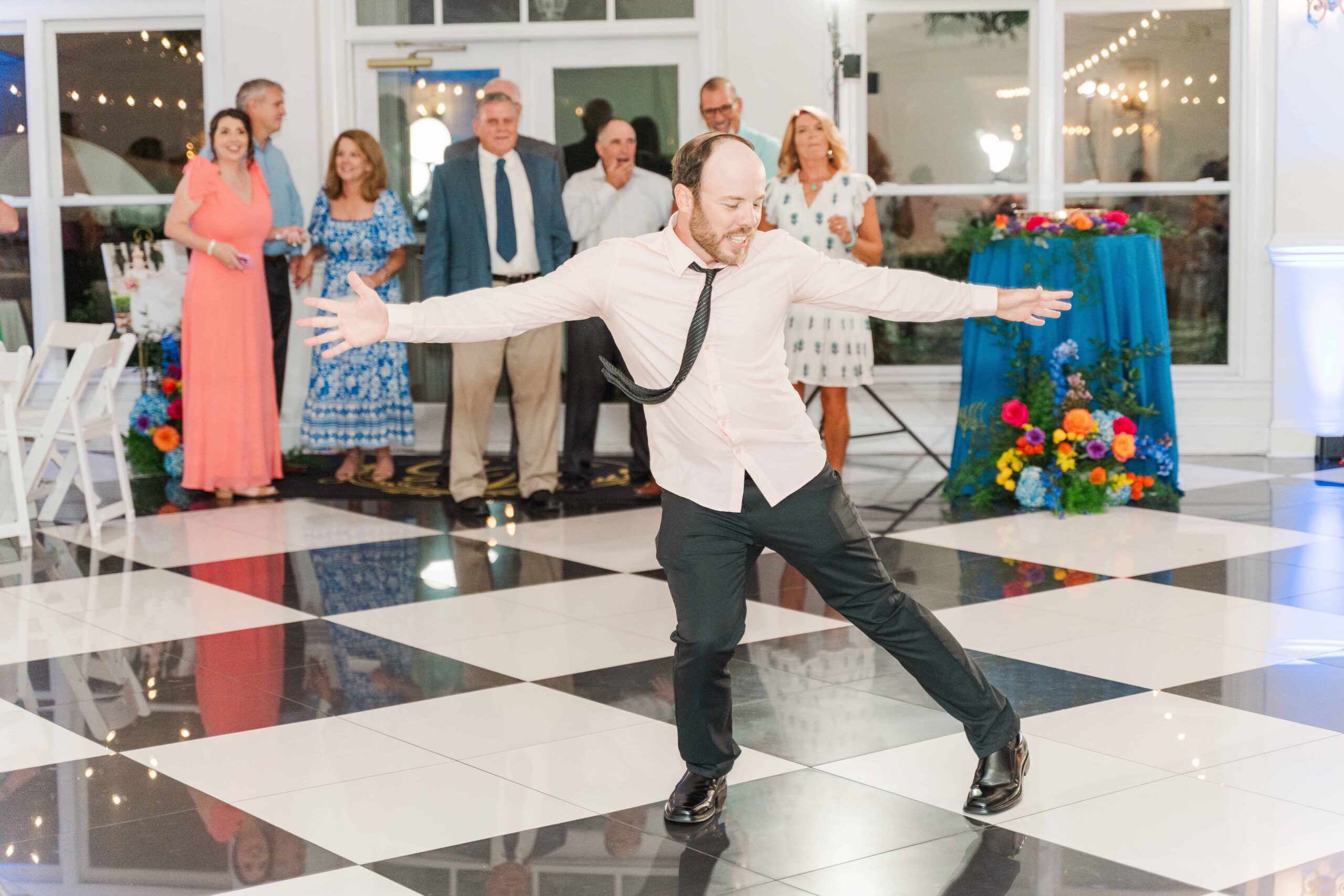 Guests laughing and dancing inside the event space at The Grande Victorian reception