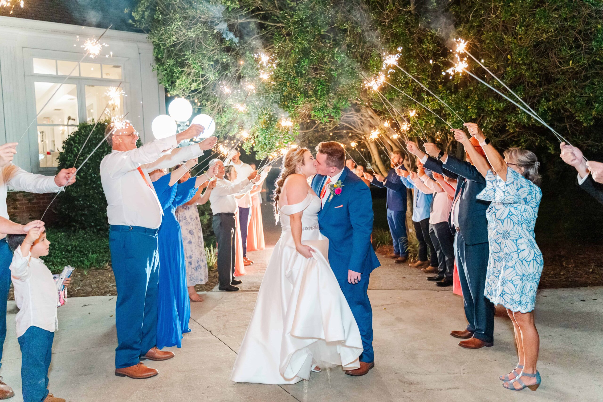 Sparkler exit at The Grande Victorian with couple smiling in front of the Victorian estate