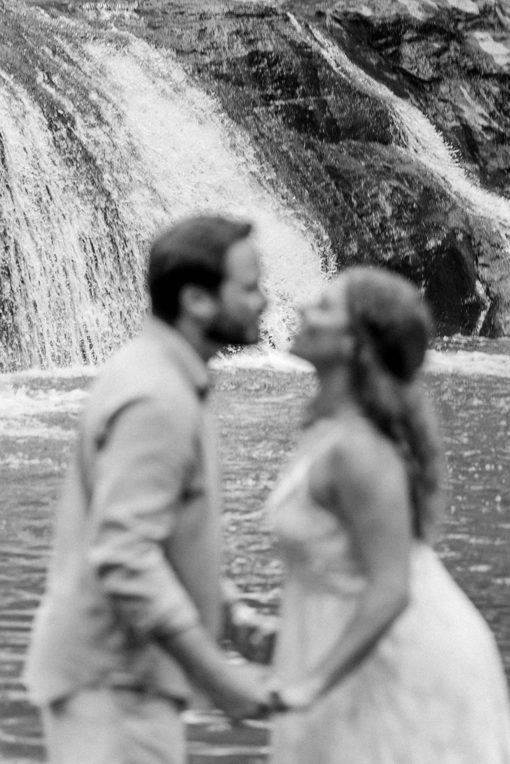 Romantic waterfall engagement photos North Carolina with couple under the cascade