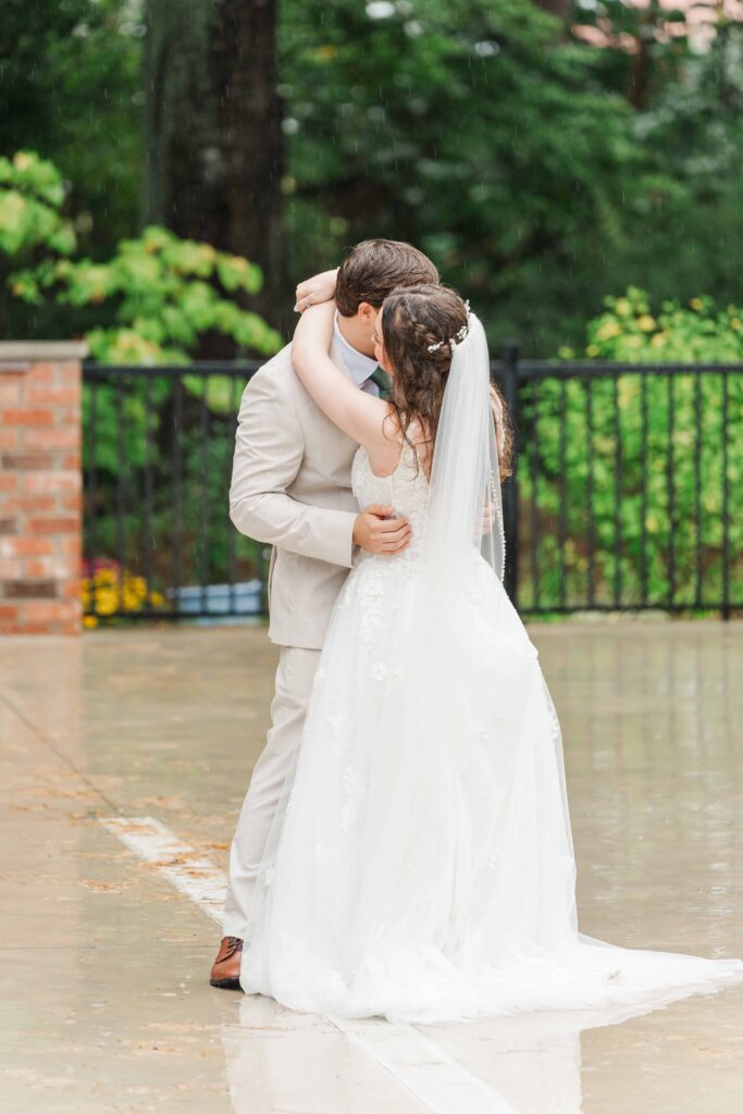 First dance in the rain on the outdoor patio at Heron Hill Venue wedding