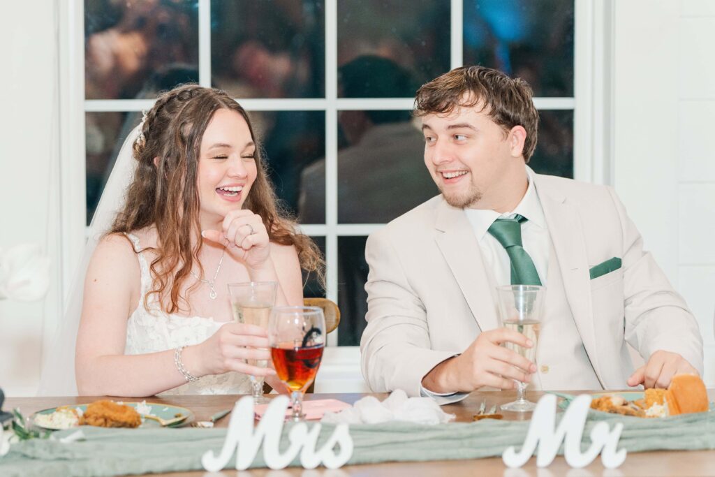 Candid moment of bride and groom laughing during Heron Hill Venue wedding day