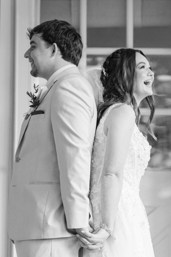 Bride laughing as she exchanges vows during first touch at Heron Hill Venue