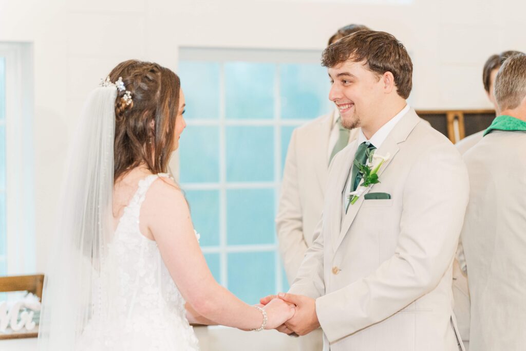 Bride and groom holding hands during stormy Heron Hill Venue wedding ceremony