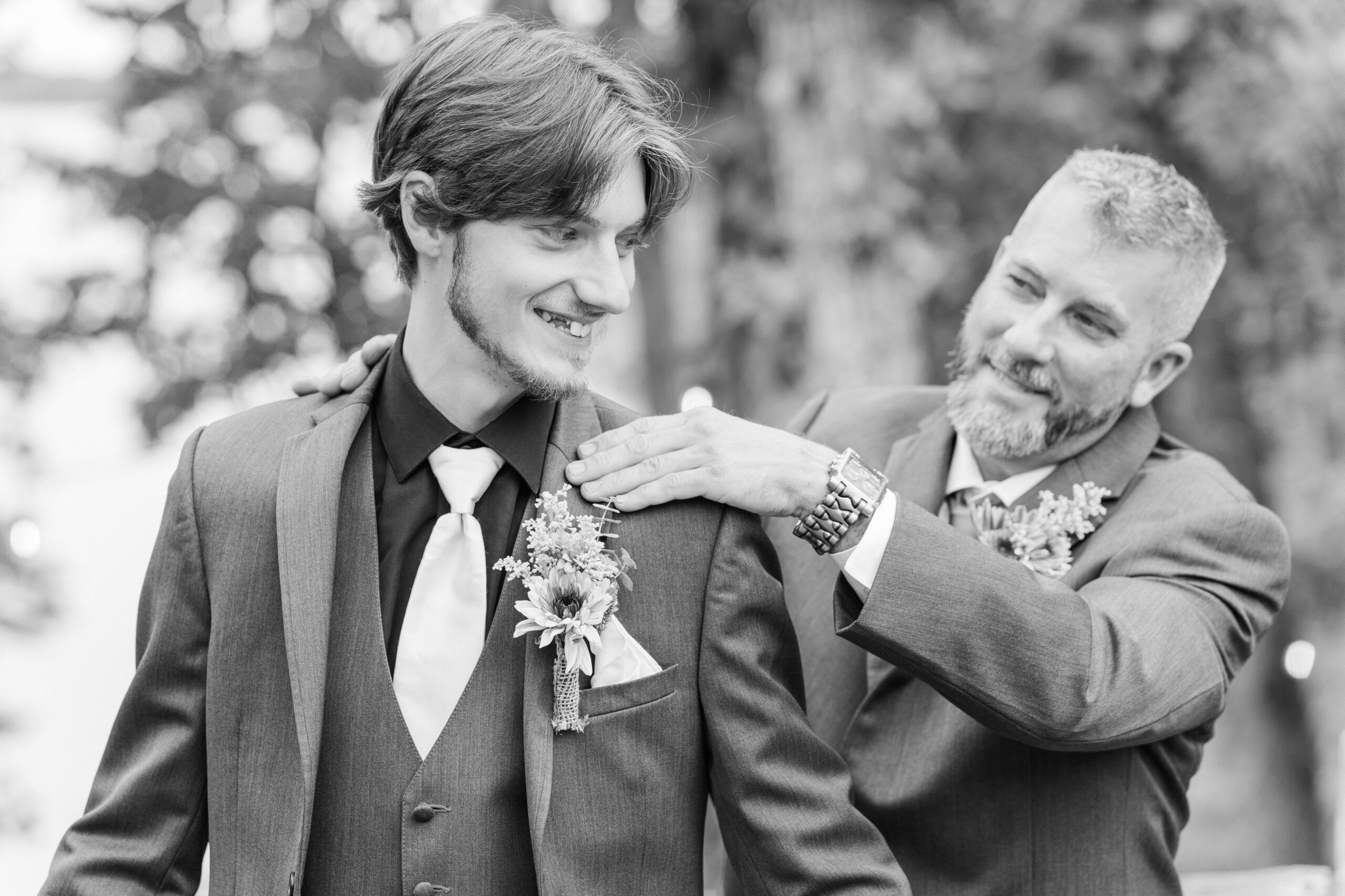 Groom adjusting his gray suit jacket before the ceremony