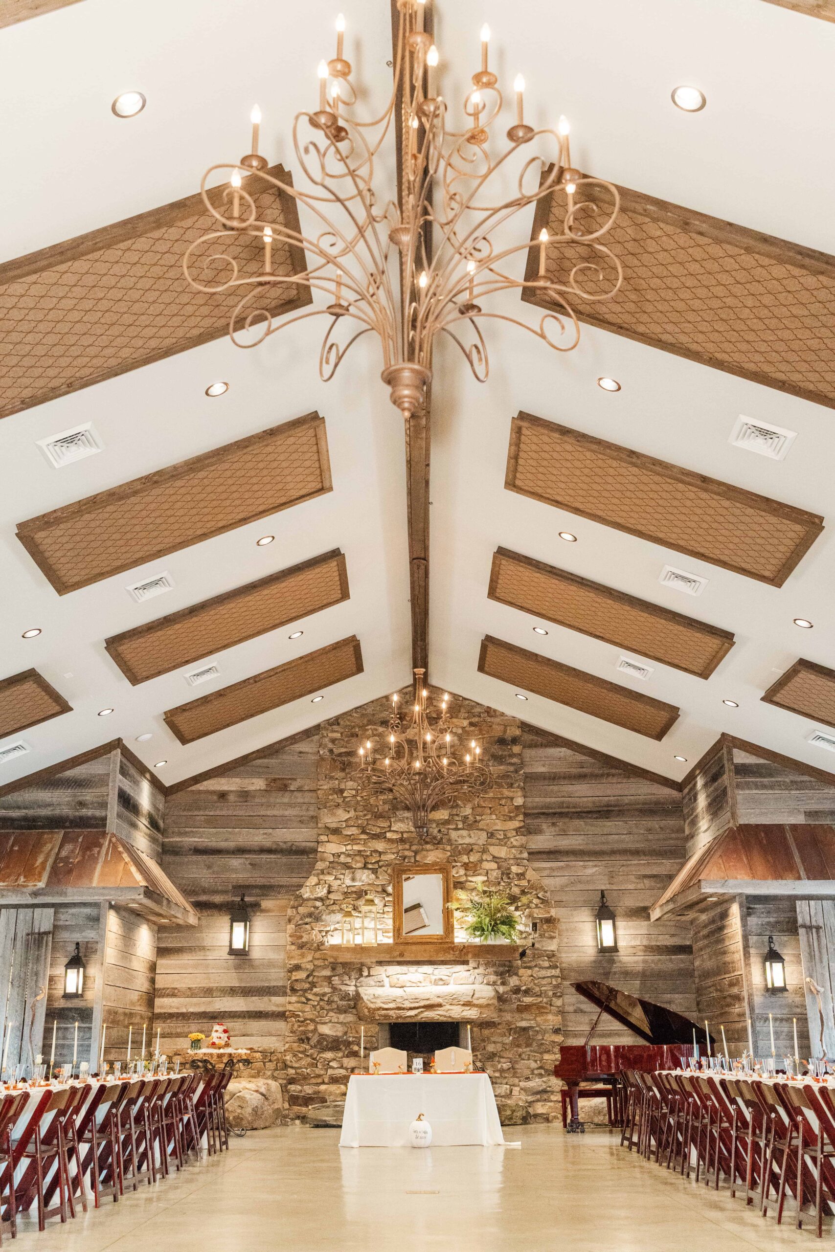 Detail photo of the stone fireplace decorated with candles and greenery