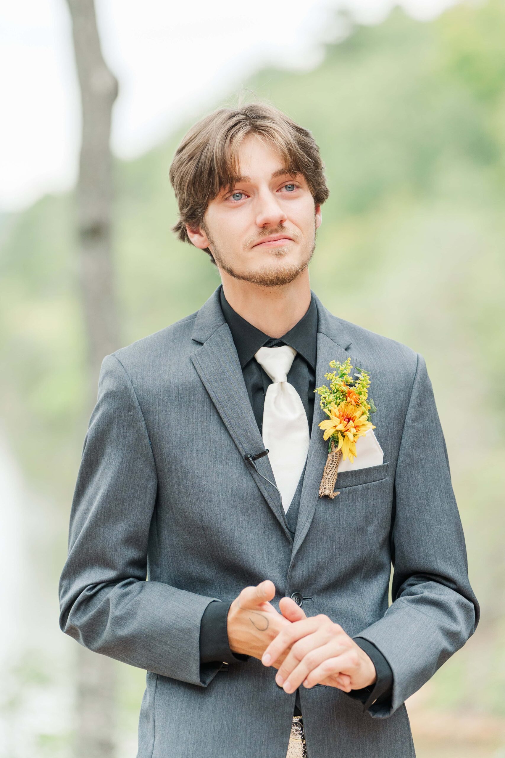 Groom in gray suit waiting at the altar at Catawba Falls Events
