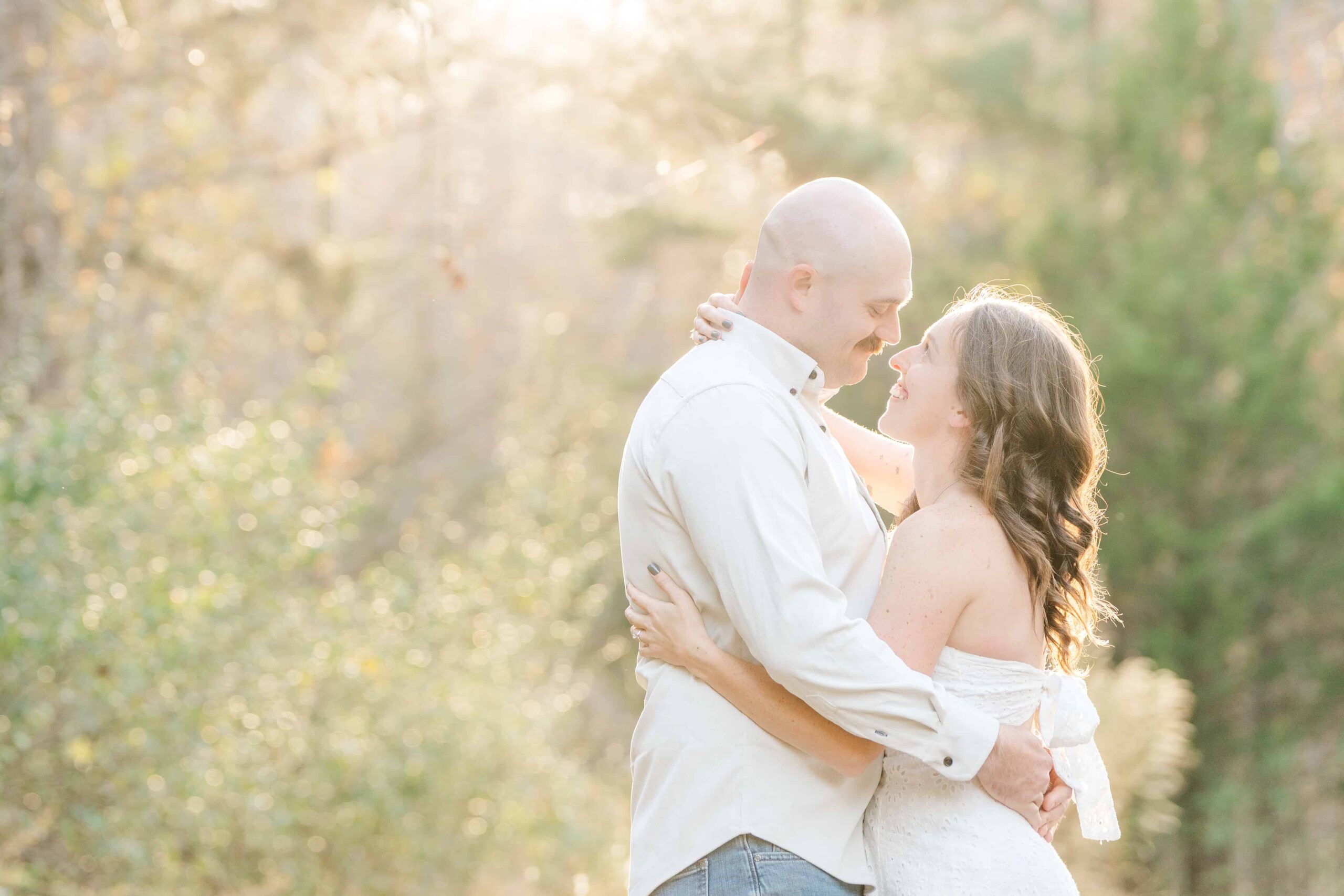 Outdoor engagement photos Charlotte featuring couple in soft golden light