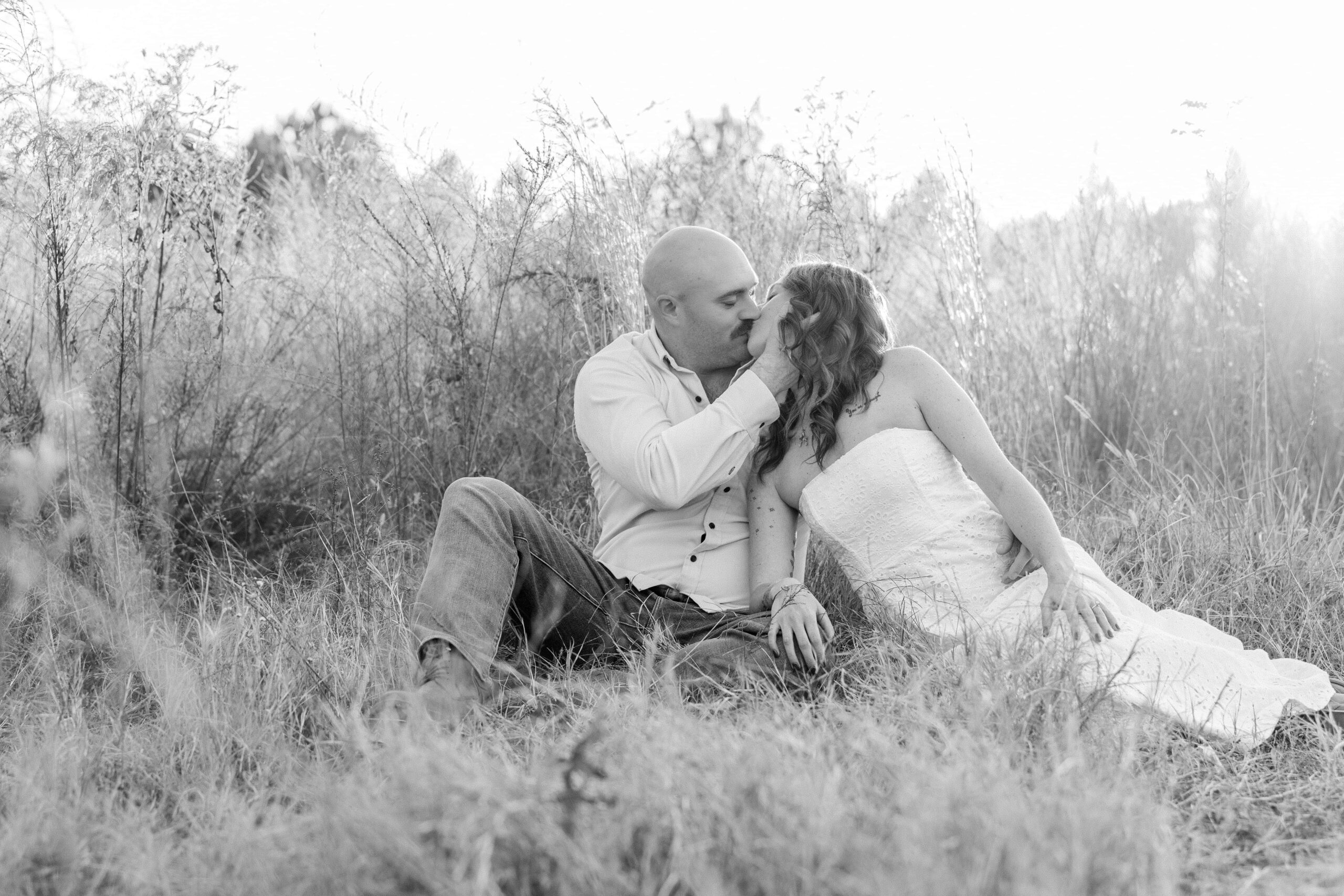 Romantic photo of engaged couple in grassy areas of Charlotte nature preserve