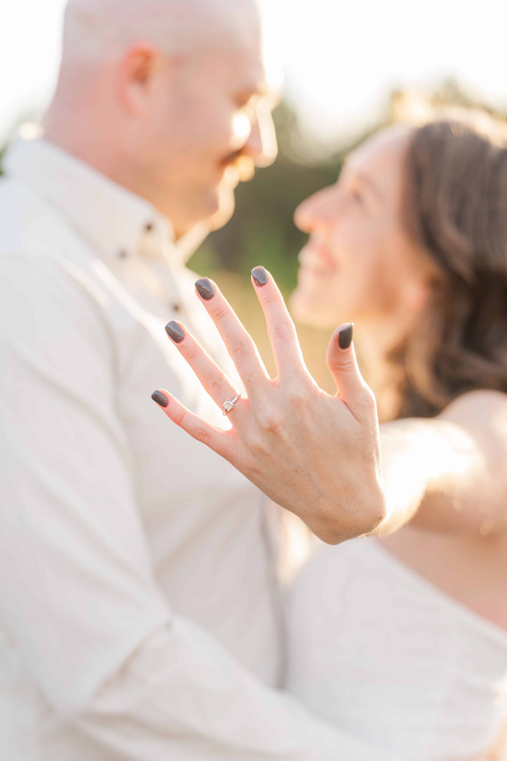 Outdoor engagement photos Charlotte featuring couple in soft golden light