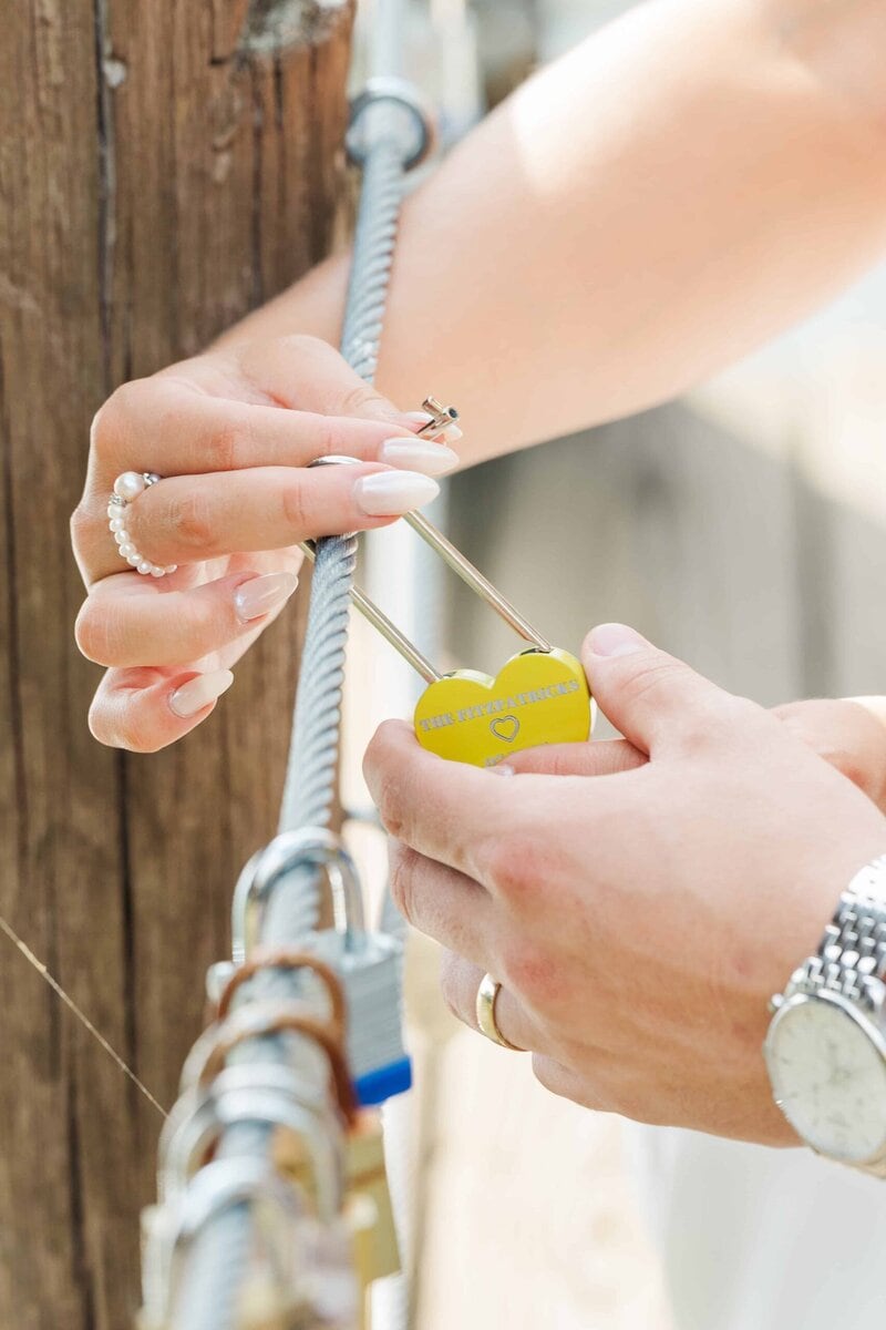 Bride and groom adding a lock to the dock at Camelot Meadows Wedding