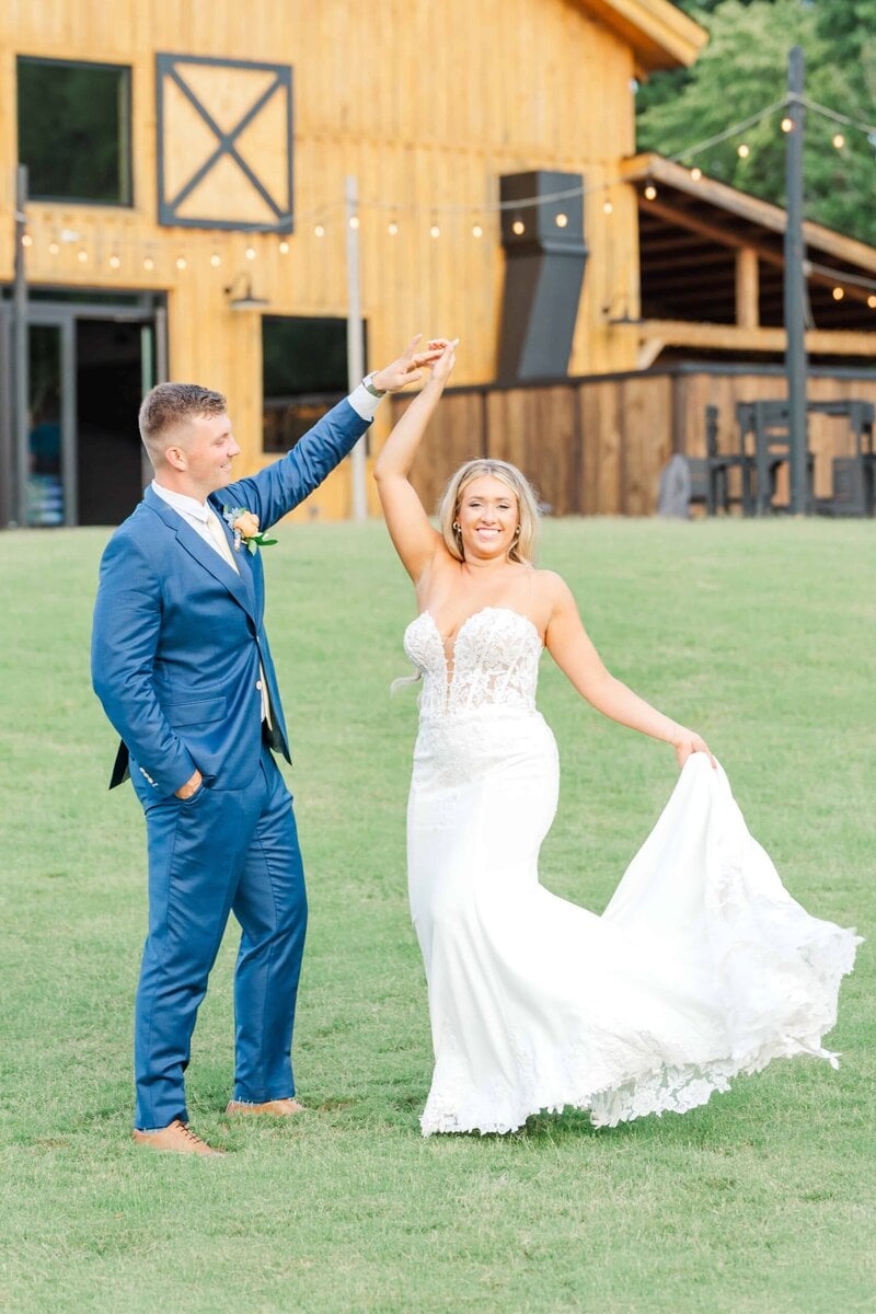 Bride and groom in a sunlit field at Camelot Meadows Event Venue