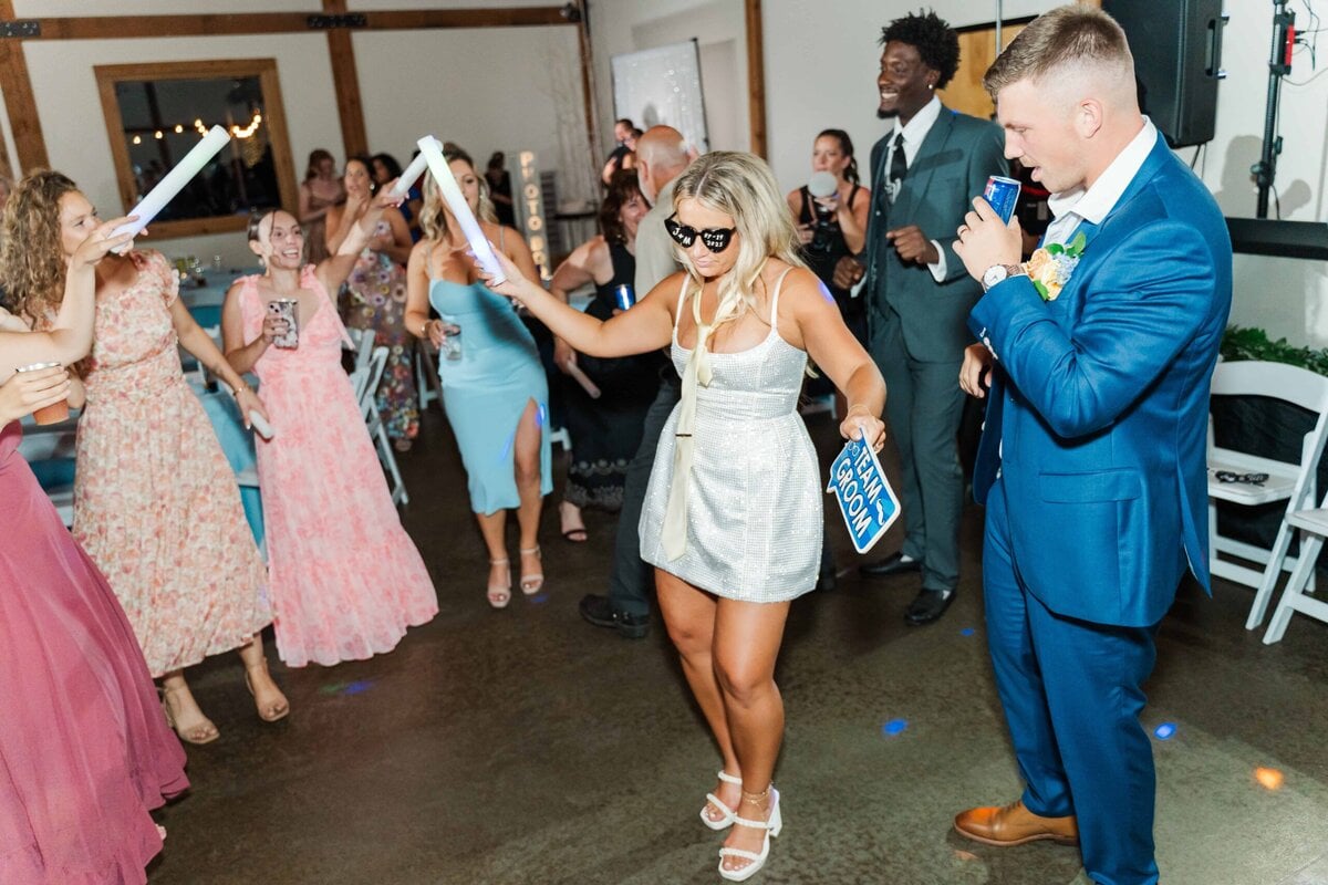 Bride dancing in her sparkly dress during the Camelot Meadows reception