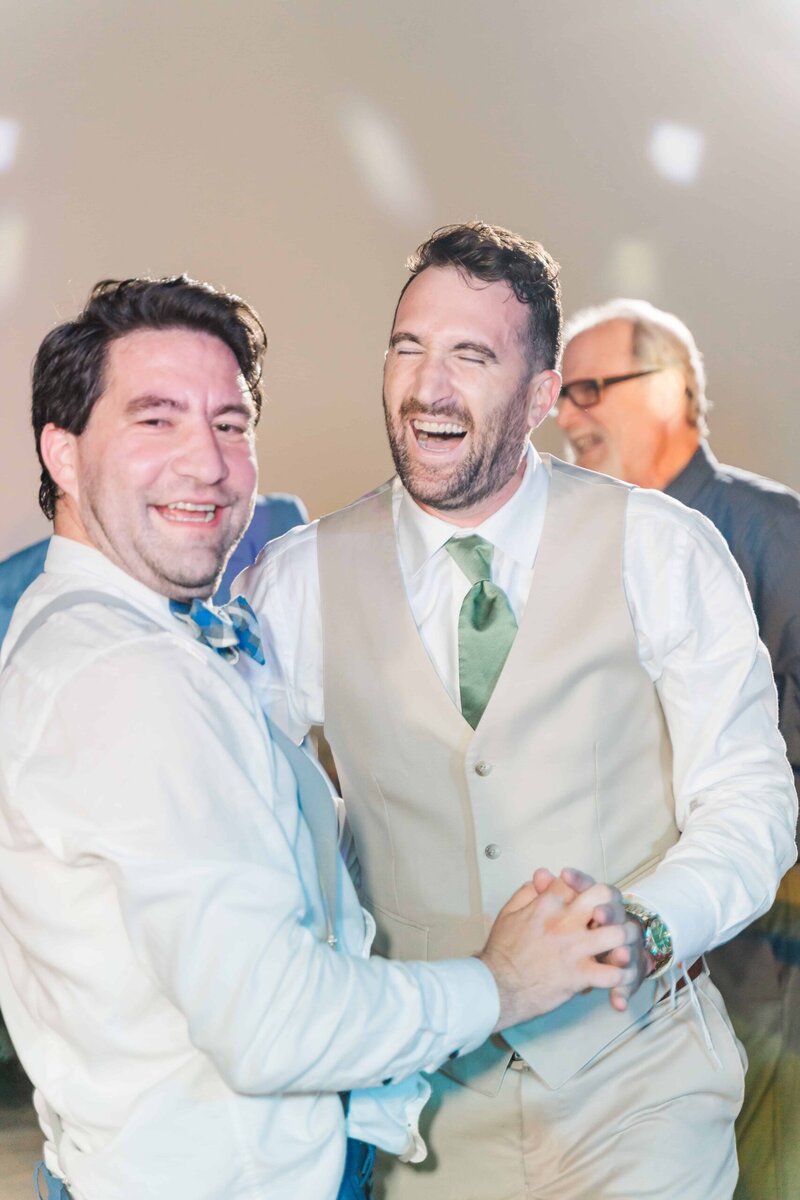 Friends celebrating on dance floor at Dugaren Vineyards Wedding